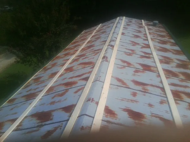 Rusted metal roof panels with new wood purlins before replacement — Storm Damage Roof Repair in King City by Roofing Brothers